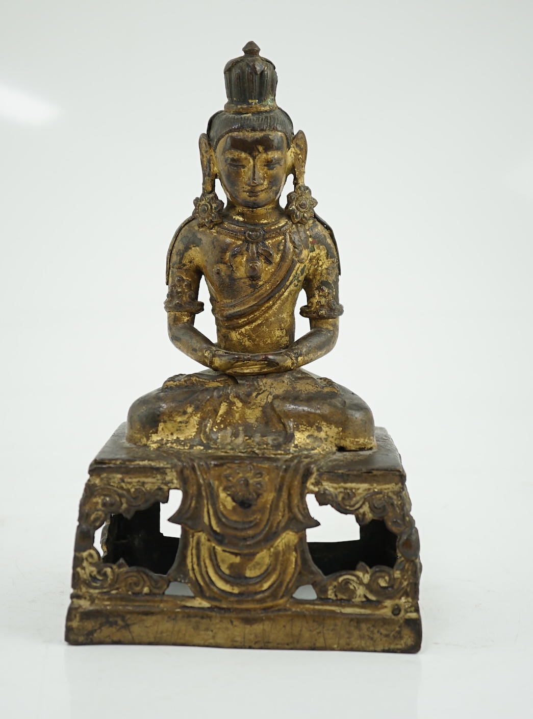 A Sino-Tibetan gilt repoussé copper alloy seated figure of Amitayus, Qianlong period, lacking aureole